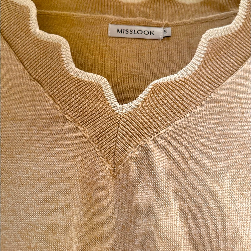Wool pullover wool sweater with scalloped neckline, hem line and cuffs.